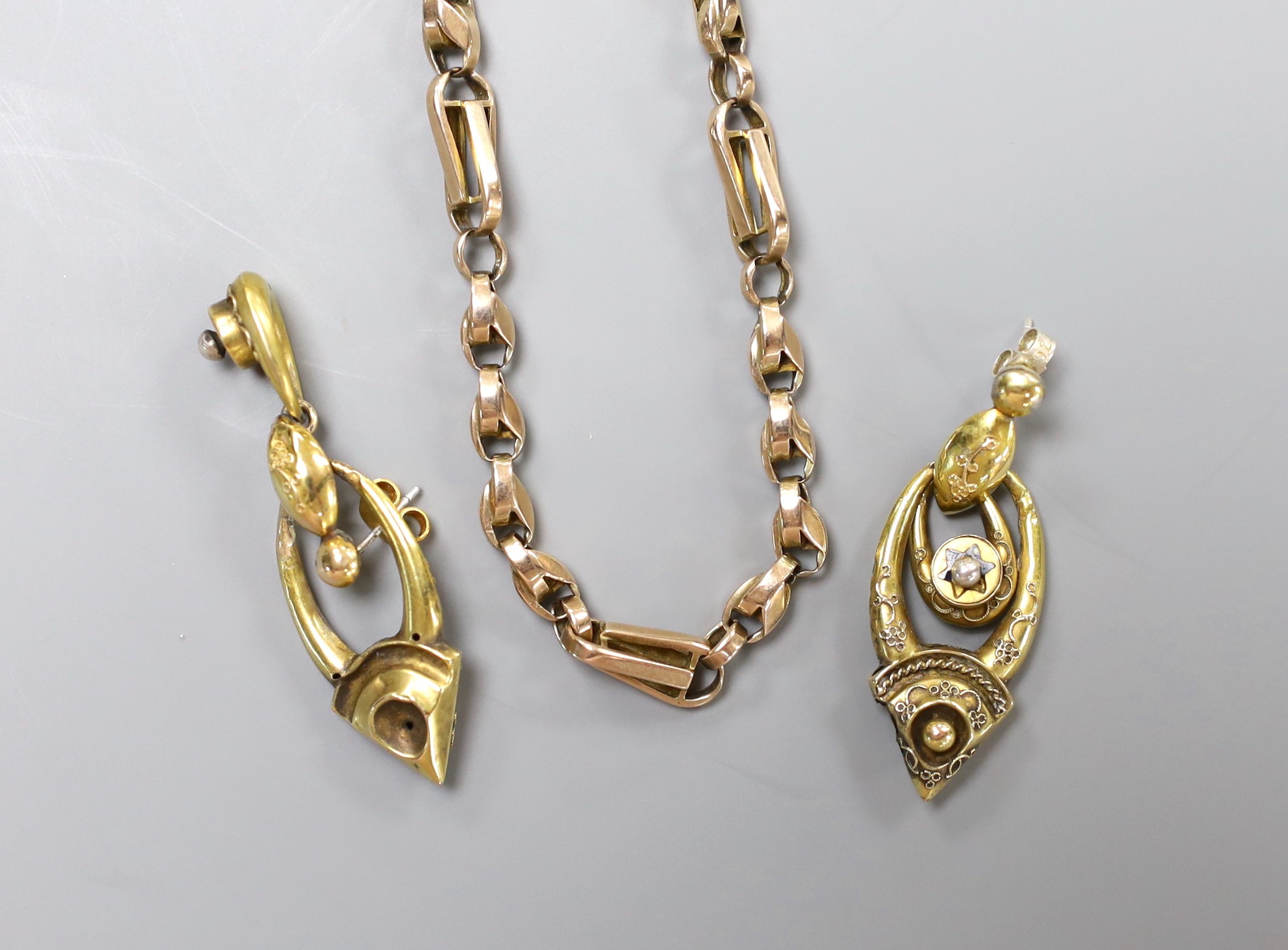 An early 20th century yellow metal necklace with gilt metal extensions, 43cmm gross 13.9 grams, together with a pair of Victorian yellow metal and black enamel set drop earrings, 40mm, gross weight 4.5 grams.